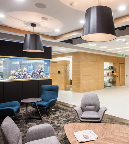 A bespoke luxury aquarium integrated into a modern corporate boardroom in Dubai, designed as office partitions and maintained by BPK Global