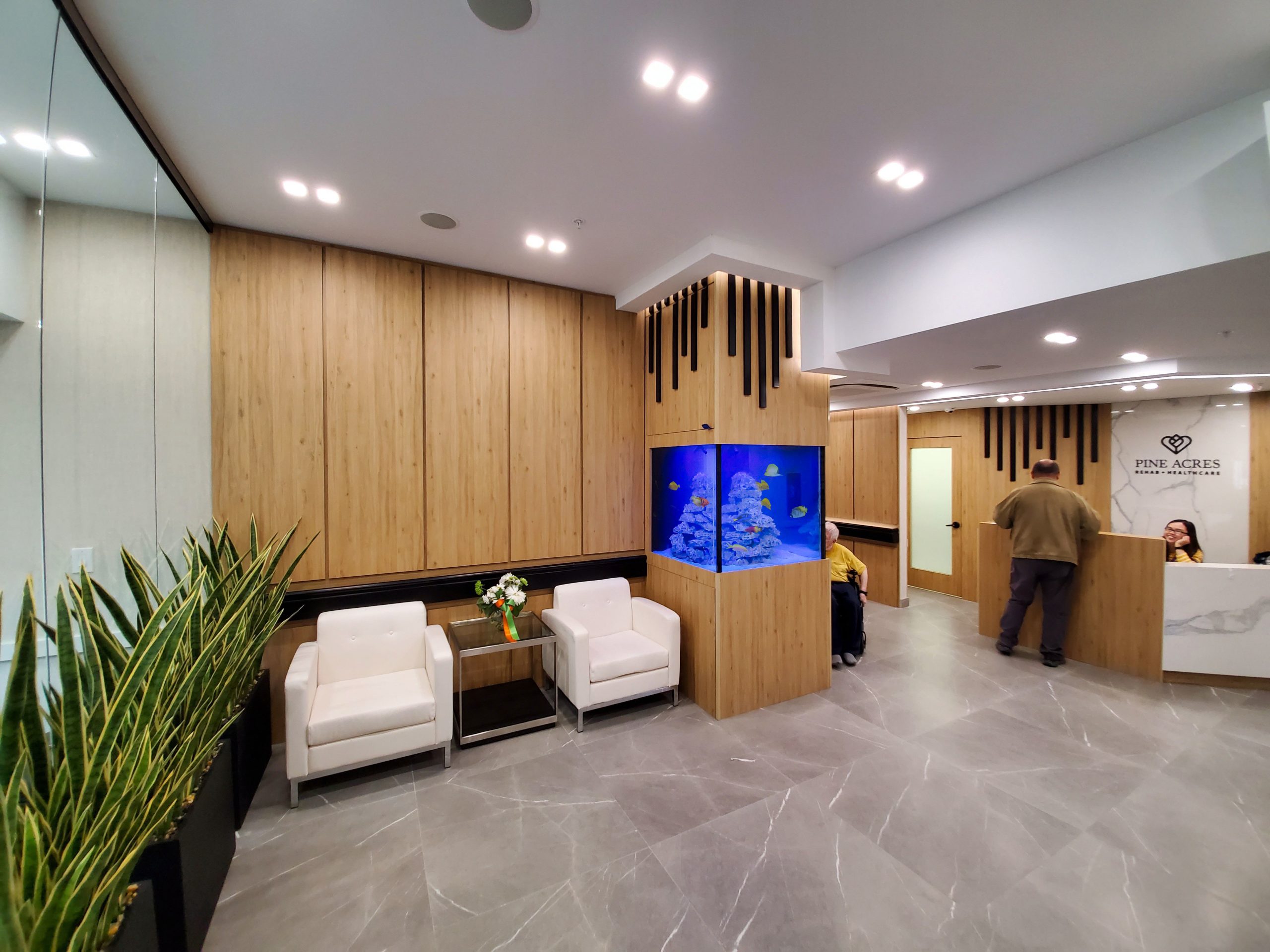 Executive lounge featuring a custom-built saltwater luxury aquarium designed to reflect biophilic architectural standards in Dubai